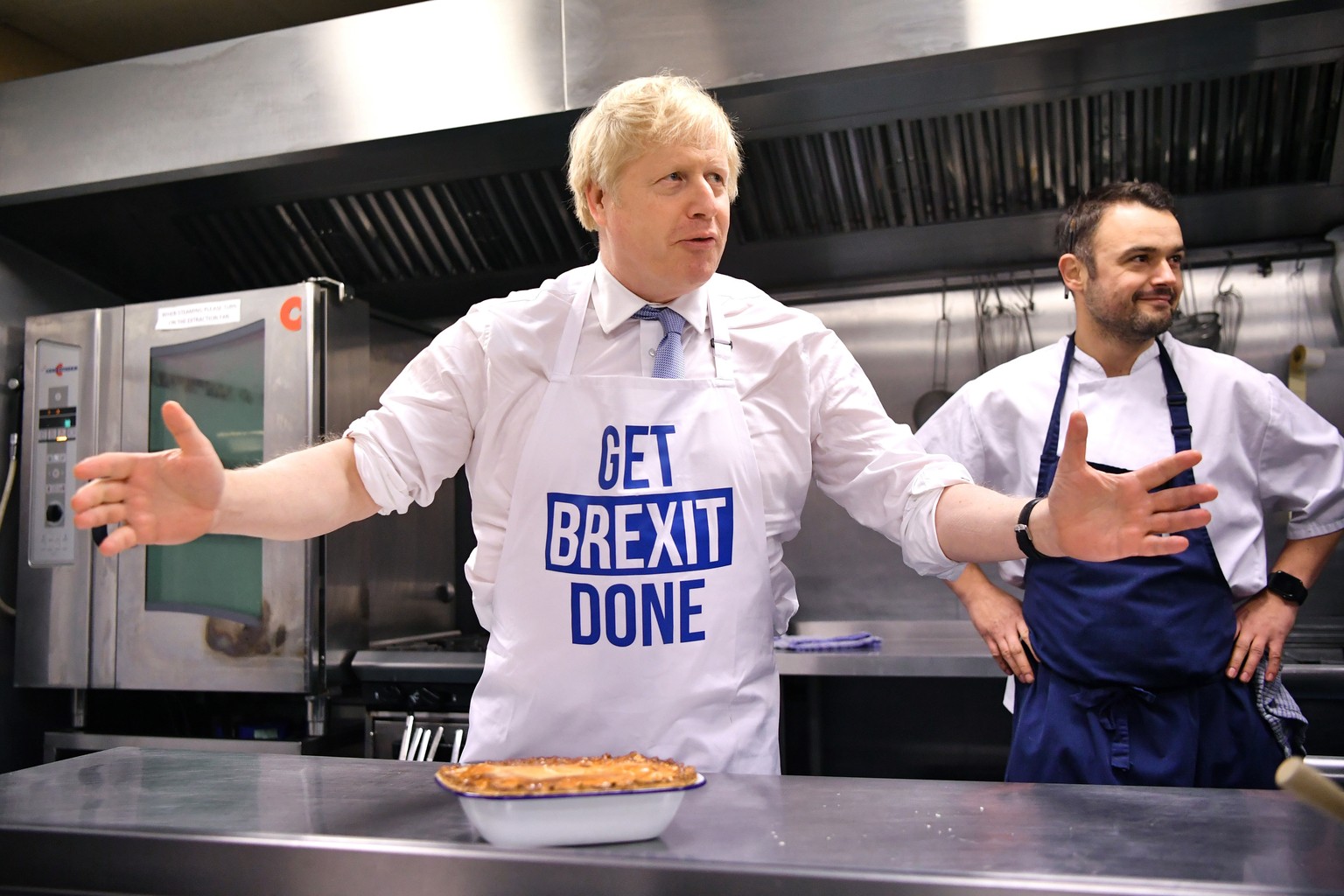 Britain&#039;s Prime Minister Boris Johnson prepares a pie at the Red Olive catering company while on the campaign trail, in Derby, England, Wednesday, Dec. 11, 2019 Britain goes to the polls on Dec.  ...