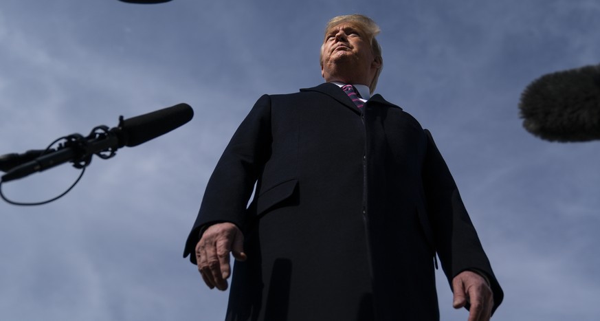 President Donald Trump talks with reporters before boarding Air Force One for a trip to Los Angeles to attend a campaign fundraiser, Tuesday, Feb. 18, 2020, in Andrews Air Force Base, Md. (AP Photo/Ev ...