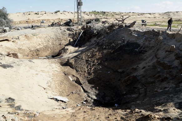 A farmer inspects a crater and the rubble of destroyed a water well following overnight Israeli missile strikes, in Rafah, southern Gaza Strip, Friday, Jan. 31, 2020. Israel launched airstrikes on mil ...
