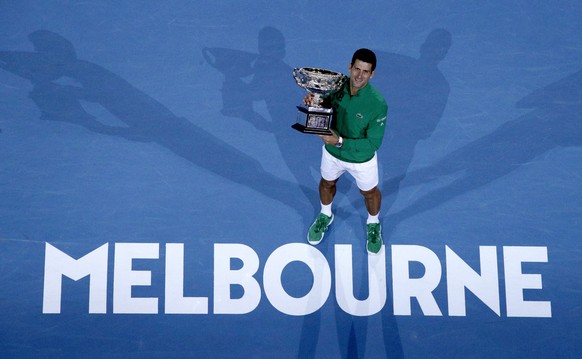 FILE - In this Monday, Feb. 3, 2020 file photo, Serbia&#039;s Novak Djokovic holds the Norman Brookes Challenge Cup after defeating Austria&#039;s Dominic Thiem in the men&#039;s singles final of the  ...