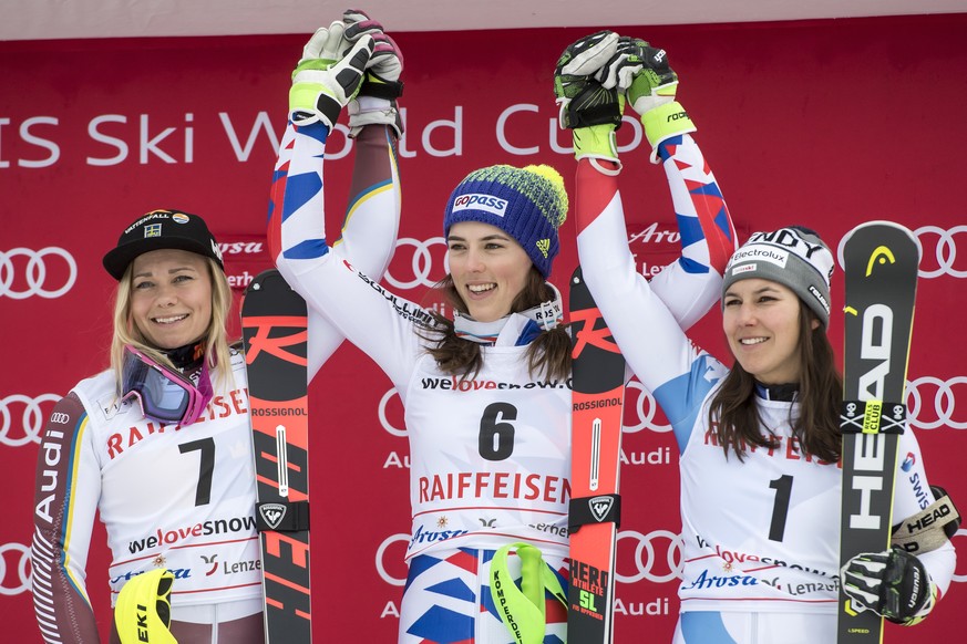 Winner Petra Vlhova of Slovakia, center, poses with second placed Frida Hansdotter of Sweden, left, and third placed Wendy Holdener of Switzerland, right, during the podium ceremony after the second r ...
