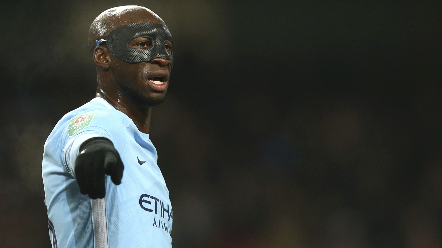 Manchester City&#039;s Eliaquim Mangala wears a face protection mask during the English League Cup semifinal first leg soccer match between Manchester City and Bristol City at the Etihad stadium in Ma ...