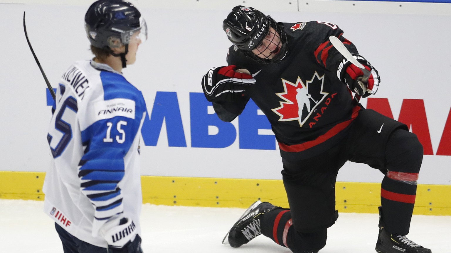 Finland&#039;s Lenni Killinen, left, skates past as Canada&#039;s Jamie Drysdale, right, celebrates after scoring his sides third goal during the U20 Ice Hockey Worlds semifinal match between Finland  ...