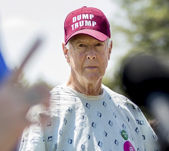 David Barrows of Washington wears a &quot;Dump Trump&quot; hat as Sen. Catherine Cortez Masto, D-Nev. speaks at a Spanish-language news conference to discuss the Senate GOP healthcare bill, Wednesday, ...