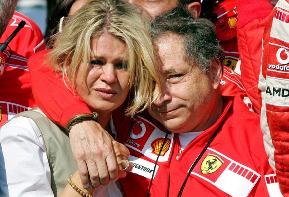 French team principal Jean Todt (R) of Scuderia Ferrari team and German Corina Schumacher (L); wife of German Formula One driver Michael Schumacher of Scuderia Ferrari team; react after Schumacher won ...