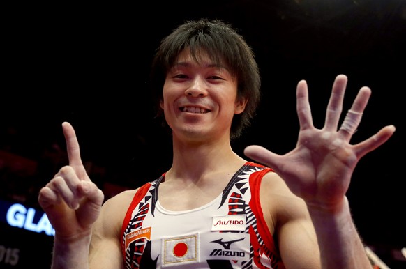 FILE - In this Oct. 30, 2015, file photo, first placed Kohei Uchimura from Japan shows the number of his world championship titles after the men&#039;s all-around final competition at the World Artist ...