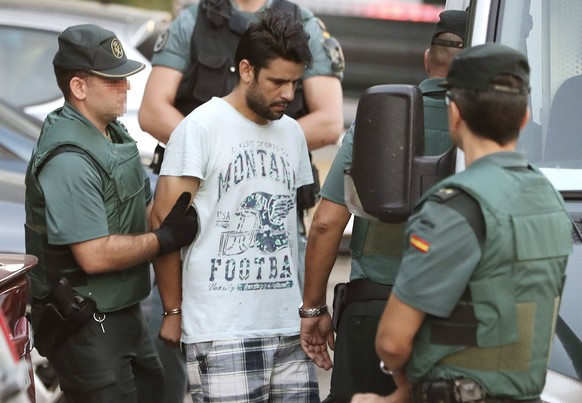 epa06155751 Mohamed Aallaa (C), 27, one of four arrested in relation to the terrorist attacks in Catalonia, is taken to the Audiencia Nacional court in Madrid, Spain, 22 August 2017. The four suspects ...