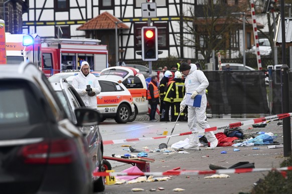 Police and rescue workers stand next to the scene of the accident with a car that is said to have crashed into a carnival parade in Volkmarsen, central Germany, Monday, Feb. 24, 2020. Several people h ...