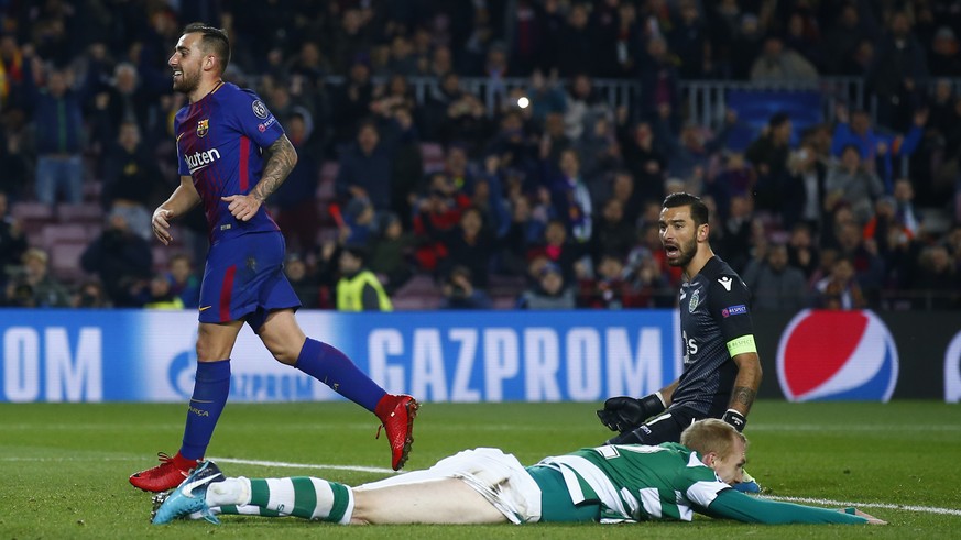 Barcelona&#039;s Paco Alcacer, left, smiles after Sporting&#039;s Jeremy Mathieu, down, scored an own goal against Sporting goalkeeper Rui Patricio, right, during the Champions League Group D soccer m ...