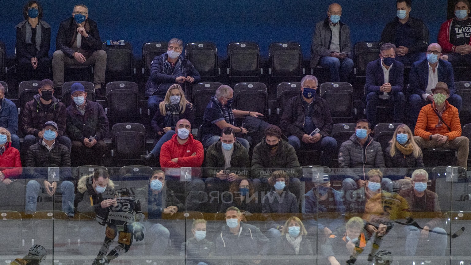 Die Zuger fans geniessen das Spiel mit Schutzmasken beim Eishockey Meisterschaftsspiel in der Qualifikation der National League zwischen dem EV Zug und dem SC Bern vom Samstag, 10. Oktober 2020 in Zug ...