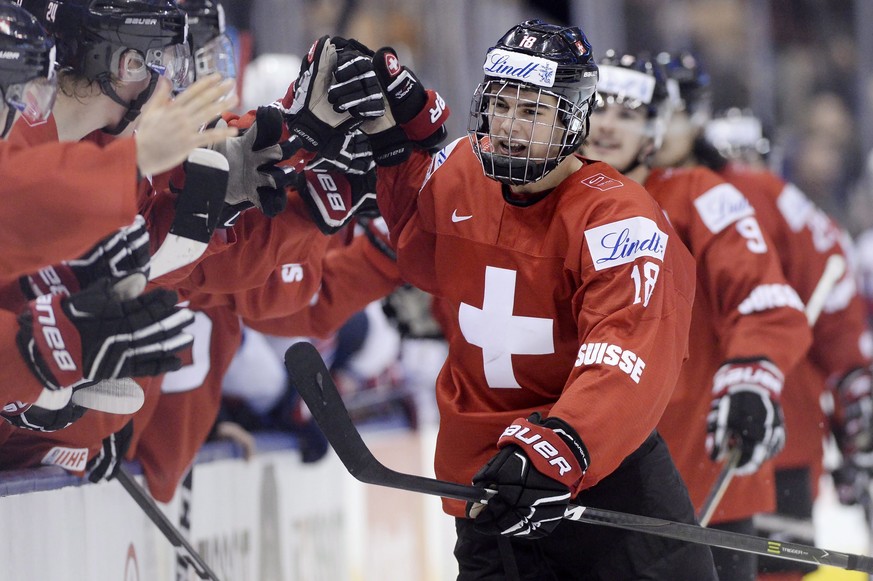 FILE - In this Jan. 2, 2017, file photo, Switzerland forward Nico Hischier (18) celebrates with teammates at the bench after scoring against the United States during the third period of a quarterfinal ...
