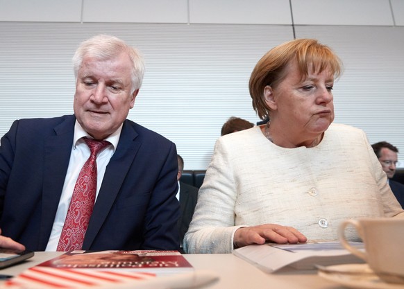 epaselect epa06802486 Minister of Interior, Construction and Homeland Horst Seehofer (L) of the Christian Social Union (CSU) and German Chancellor Angela Merkel (R) of the Christian Democratic Union ( ...
