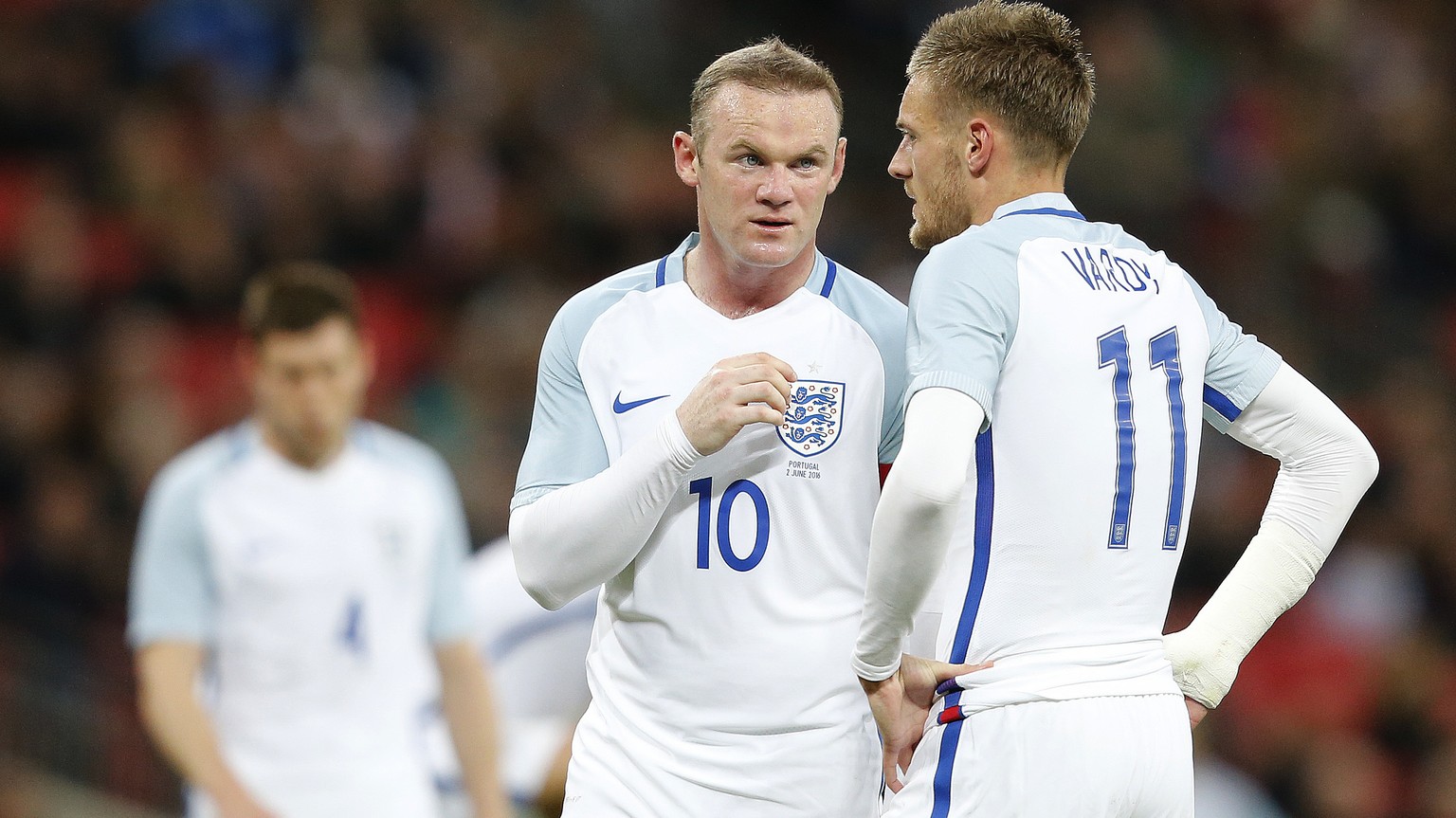England&#039;s Wayne Rooney, center, talks to England&#039;s Jamie Vardy during the International friendly soccer match between England and Portugal at Wembley stadium in London, England, Thursday, Ju ...