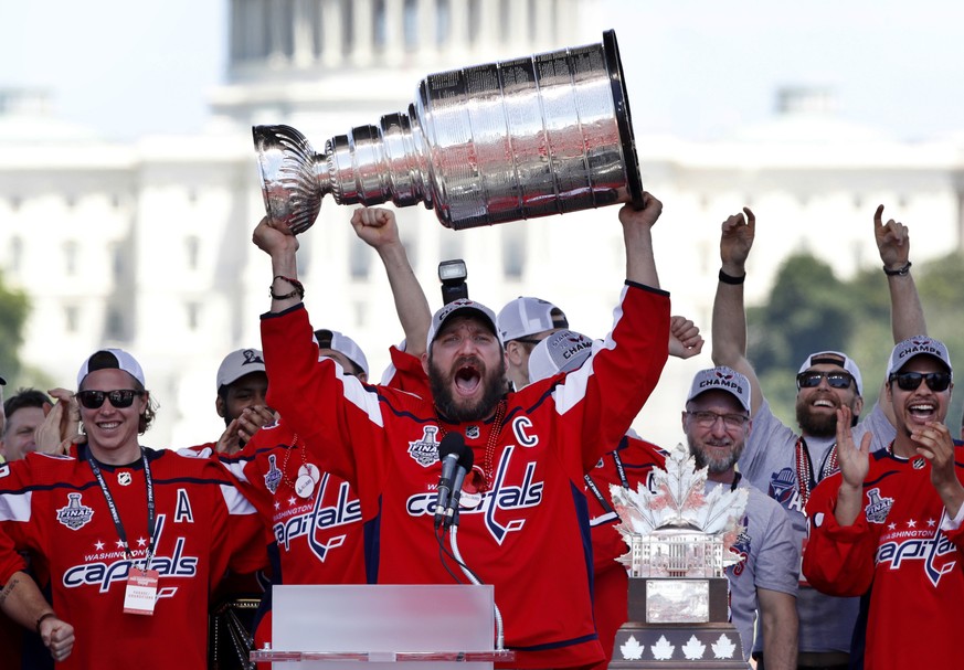 FILE - In this Tuesday, June 12, 2018 file photo Washington Capitals Alex Ovechkin, from Russia, holds up the Stanley Cup trophy during the NHL hockey team&#039;s Stanley Cup victory celebration, at t ...
