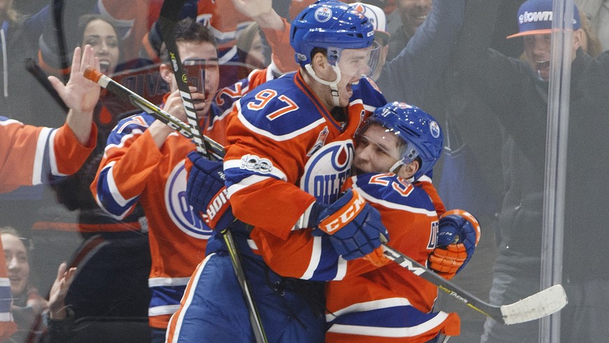 Edmonton Oilers&#039; Connor McDavid (97) and Leon Draisaitl (29) celebrate a goal during overtime against the Anaheim Ducks in an NHL hockey game Saturday, April 1, 2017, in Edmonton, Alberta. (Jason ...