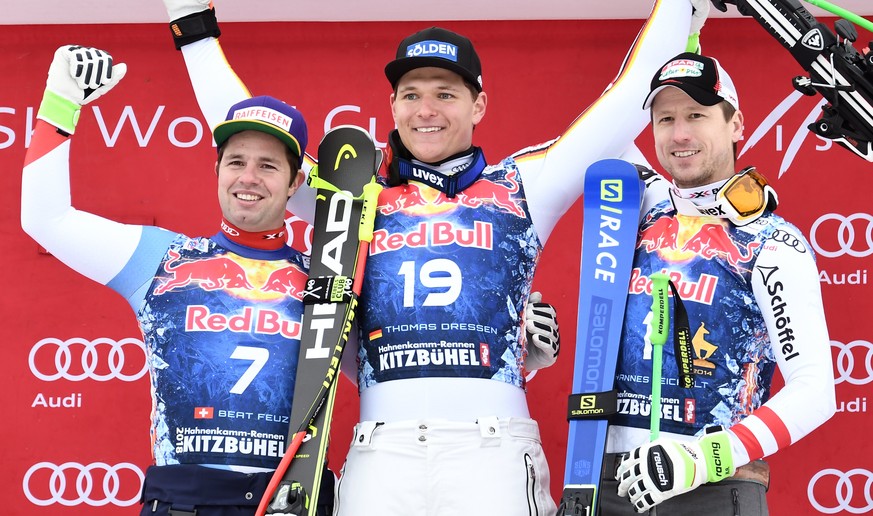 epa06457070 Second placed Beat Feuz of Switzerland (L), winner Thomas Dressen of Germany (C) and third placed Hannes Reichelt of Austria (R) react on the podium after the Men&#039;s Downhill race of t ...