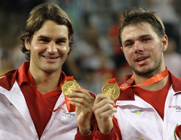 FILE- In this Saturday, Aug. 16, 2008, file photo, Roger Federer, left, and Stanislas Wawrinka of Switzerland celebrate winning the men&#039;s tennis doubles gold medal at the Beijing 2008 Olympics in ...