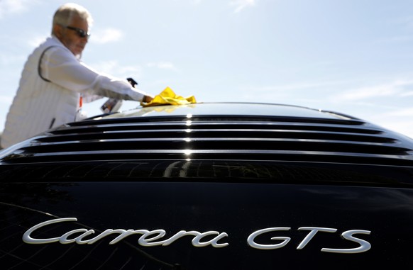 epa07534370 A man cleans his car on display during the 1st Porsche Festival in Cannes, 28 April 2019. The event will take place from 27 to 28 April. EPA/SEBASTIEN NOGIER