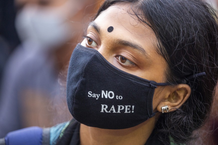 epa08738141 A student wearing a face mask with slogan participates in a cultural event as part of a protest against rape and sexual assaults on women as they demand justices at the Shahbagh area in Dh ...
