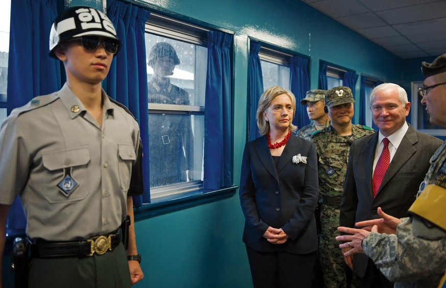 U.S. Army Col. Kurt Taylor, right, briefs U.S. Secretary of State Hillary Rodham Clinton, center, and U.S. Secretary of Defense Robert Gates, 2nd right, at the truce village of Panmunjom in the demili ...