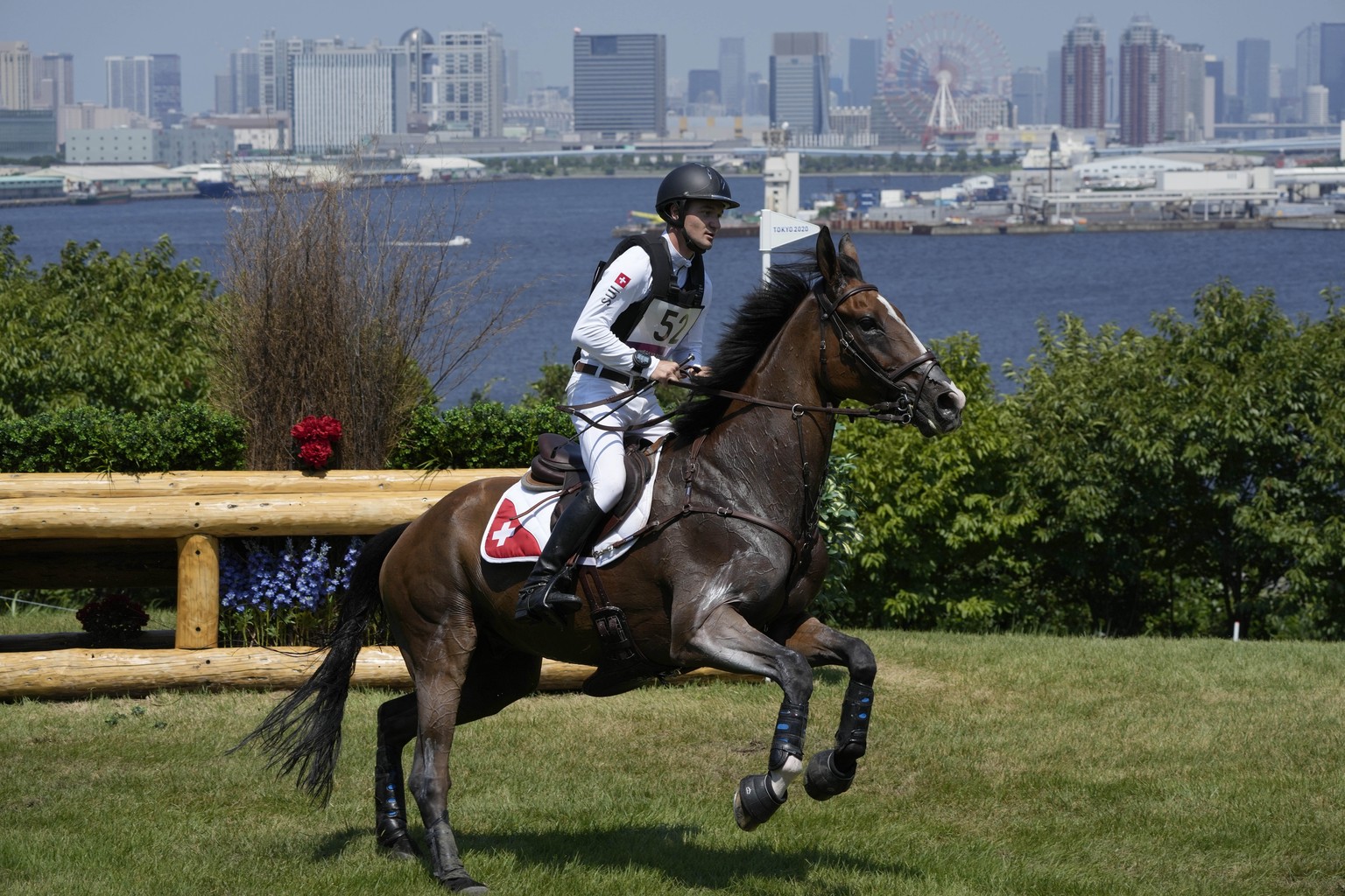 Switzerland&#039;s Robin Godel, riding Jet Set, competes during the Equestrian Eventing Cross Country competition at the Sea Forest Cross Country Course during the 2020 Summer Olympics, Sunday, Aug. 1 ...