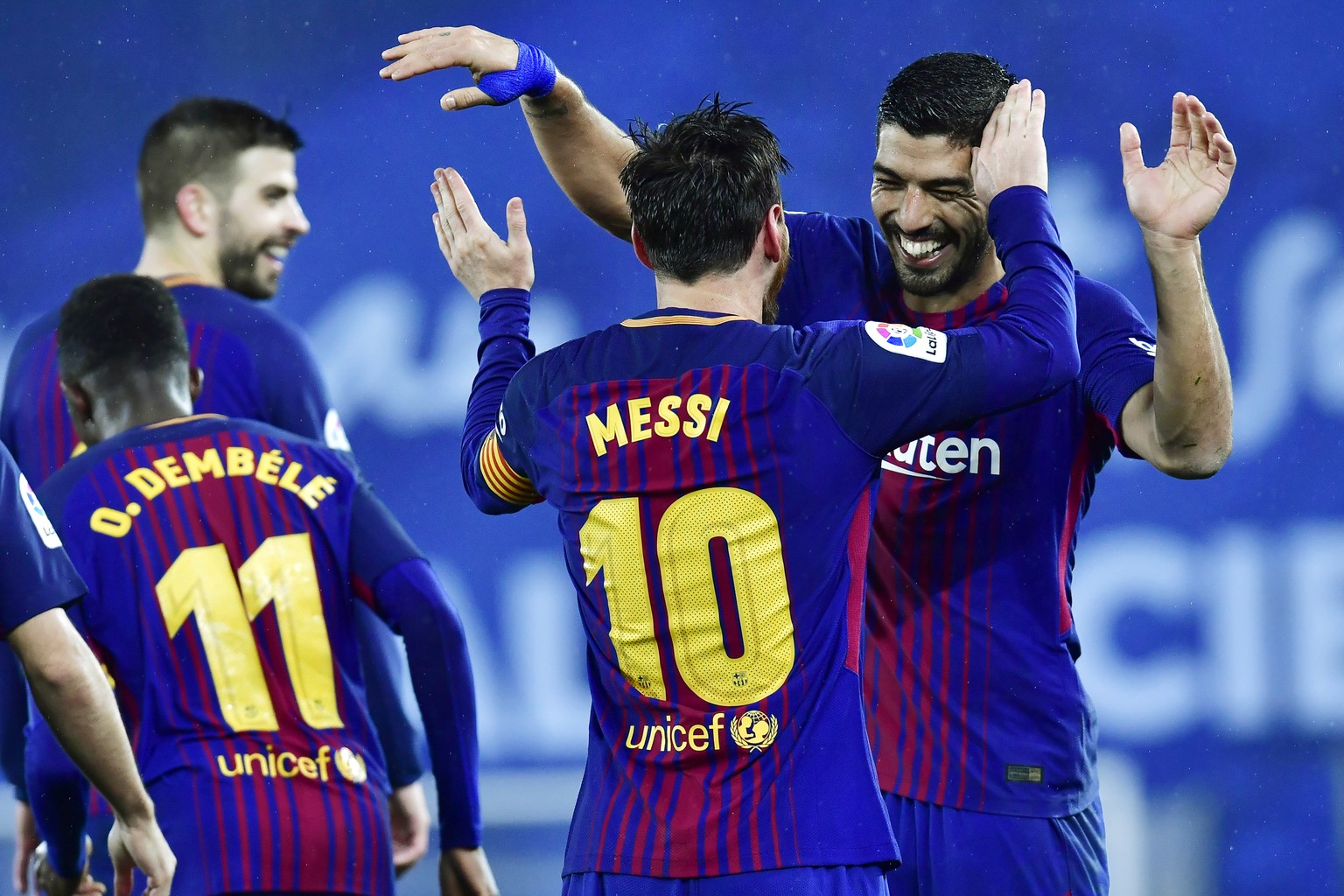 FC Barcelona&#039;s Lionel Messi celebrates with Luis Suarez, right, after scoring the fourth goal of his team during the Spanish La Liga soccer match between Barcelona and Real Sociedad, at Anoeta st ...