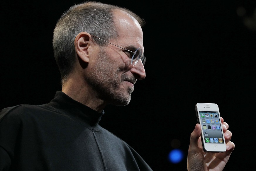 SAN FRANCISCO - JUNE 07: Apple CEO Steve Jobs holds the new iPhone 4 after he delivered the opening keynote address at the 2010 Apple World Wide Developers conference June 7, 2010 in San Francisco, Ca ...