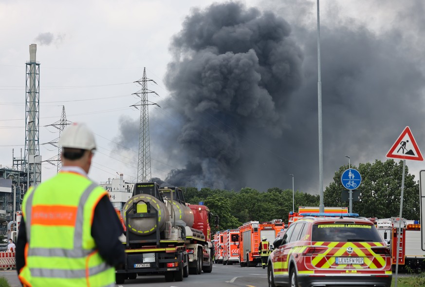 dpatopbilder - 27.07.2021, Nordrhein-Westfalen, Leverkusen: Einsatzfahrzeuge der Feuerwehr stehen unweit einer Zufahrt zum Chempark