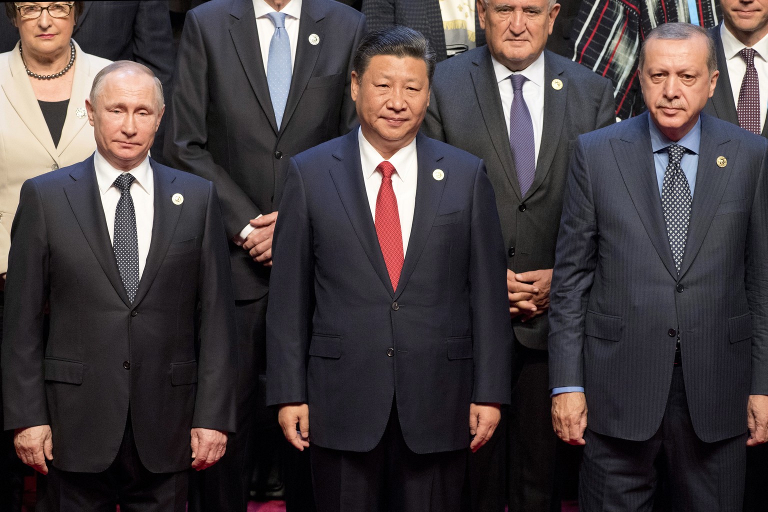 Chinese President Xi Jinping, center, stands with Russian President Vladimir Putin, left, Turkish President Recep Tayyip Erdogan, right, and other leaders to pose for a group photo prior to the openin ...