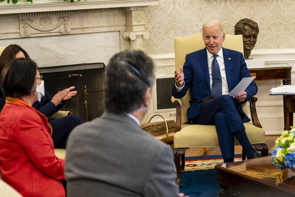 epa09137944 US President Joe Biden (R) speaks during a meeting with the Congressional Asian Pacific American Caucus Executive Committee in the Oval Office of the White House in Washington, DC, USA, on ...
