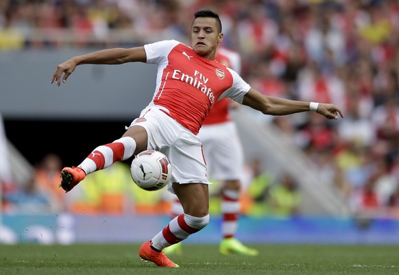 FILE - This is a Saturday, Aug. 2, 2014 file photo of Arsenal&#039;s Alexis Sanchez, new signing as he controls the ball during the Emirates Cup soccer match between between Arsenal and Benfica at Ars ...