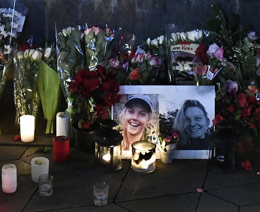 epaselect epa07251812 A portrait of Louisa and Maren are seen at a makeshift memorial among flowers and candles, in Town Hall Square in Copenhagen, Denmark, 28 December 2018. The bodies of Maren Uelan ...