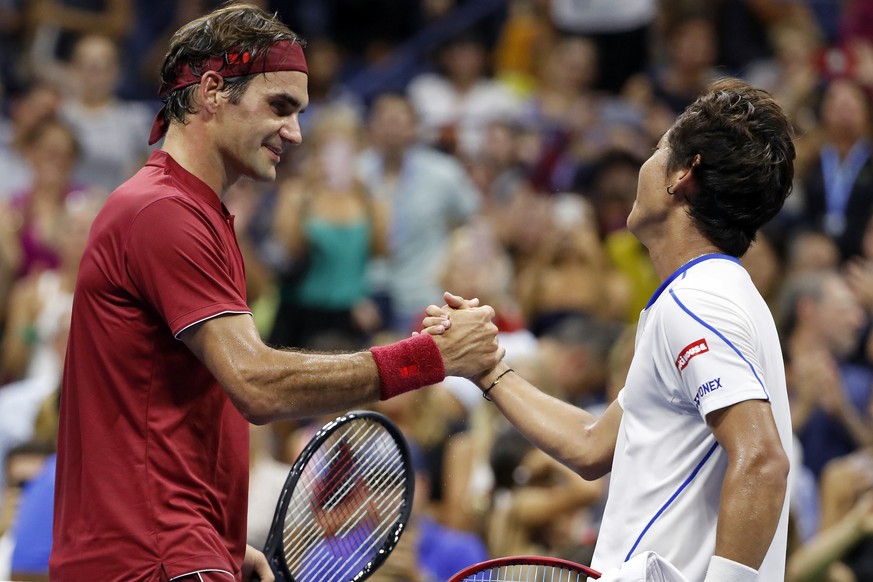 Roger Federer, of Switzerland, left, shakes hands with Yoshihito Nishioka, of Japan, after defeating him during the first round of the U.S. Open tennis tournament, Tuesday, Aug. 28, 2018, in New York. ...