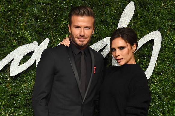 Former soccer player David Beckham and designer Victoria Beckham pose for photographers upon arrival at The British Fashion Awards 2014, in London, Monday, Dec. 1, 2014. (Photo by Jonathan Short/Invis ...