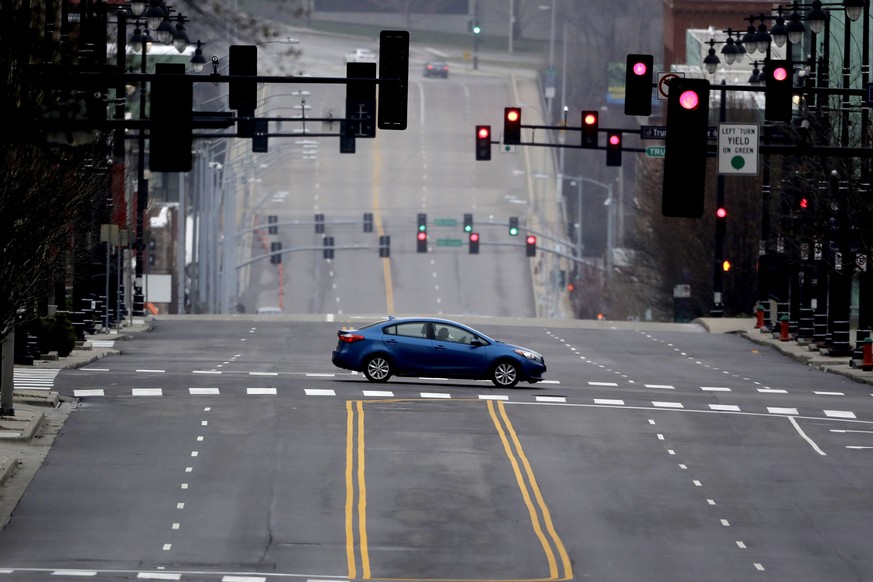 A motorist crosses an empty downtown street in Kansas City, Mo. Sunday, March 22, 2020. Officials in Missouri&#039;s largest cities are ordering a mandatory stay-at-home rule to residents starting nex ...