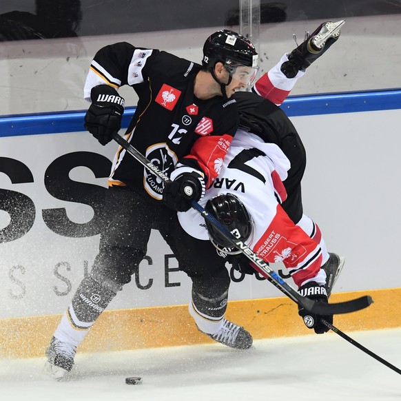 Lugano&#039;s player Luca Cunti, left, fights for the puck with Banska Bystrica&#039;s player Robert Varga, right, during the Champions Hockey League group H match between Switzerland&#039;s HC Lugano ...