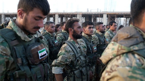 epa07907084 Turkey-backed members of Syrian National Army prepare for moving to Turkey for an expected military operation by Turkey into Kurdish areas of northern Syria, in Azas near Turkey border, Sy ...