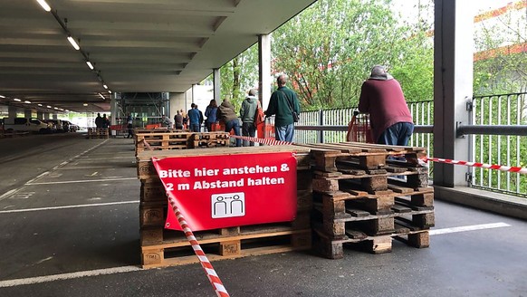 Rund 60 Personen warten vor der Bauhaus-Filiale in Niederwangen BE auf Einlass.