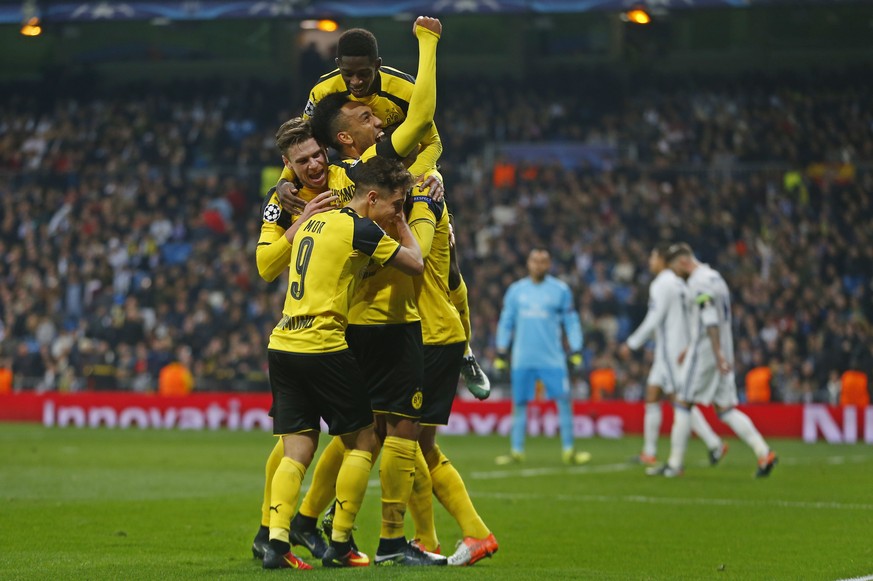 Dortmund players celebrate after Marco Reus scored his side&#039;s 2nd goal during the Champions League, Group F, soccer match between Real Madrid and Borrusia Dortmund at the Santiago Bernabeu stadiu ...