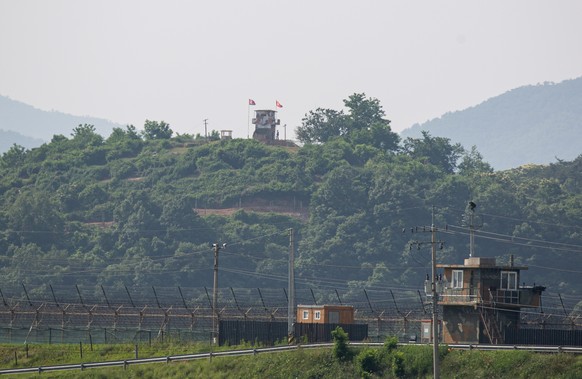 epa08474133 A North Koren watchtower (C, top) and a South Korean on (R) face each other across the inter-Korean border near the city of Paju, Gyeonggi-do, South Korea, 09 June 2020. North Korea announ ...
