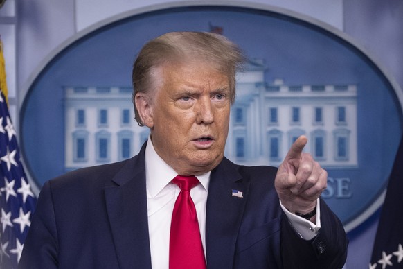 FILE - President Donald Trump points to a question as he speaks during a briefing with reporters in the James Brady Press Briefing Room of the White House, in Washington. TikTok and its U.S. employees ...