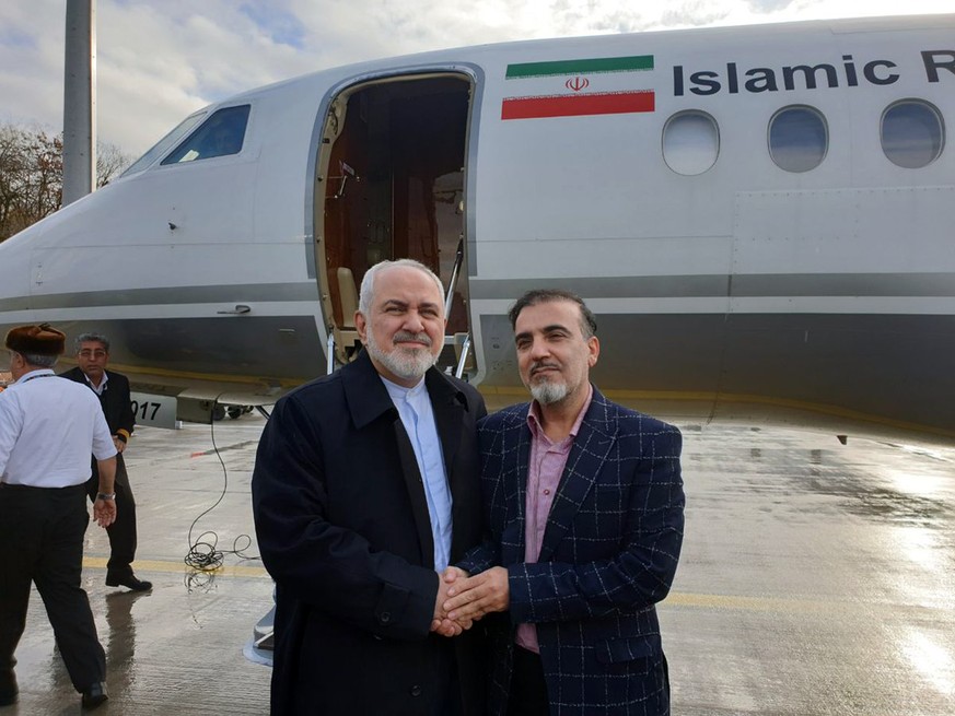 In this photo released on twitter account of Iran&#039;s Foreign Minister Mohammad Javad Zarif , Zarif, left, shakes hand with Iranian scientist Massoud Soleimani prior to leaving Zurich, Switzerland  ...