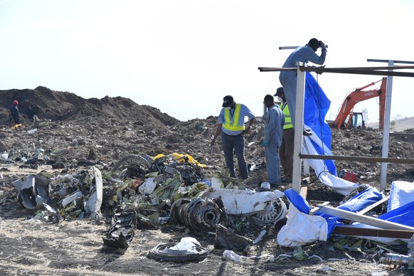 epa07484136 (FILE) - Rescue workers search the site for pieces of the wreckage of an Ethiopia Airlines Boeing 737 Max 8 aircraft near Bishoftu, Ethiopia, 13 March 2019. Ethiopian Airlines flight ET 30 ...