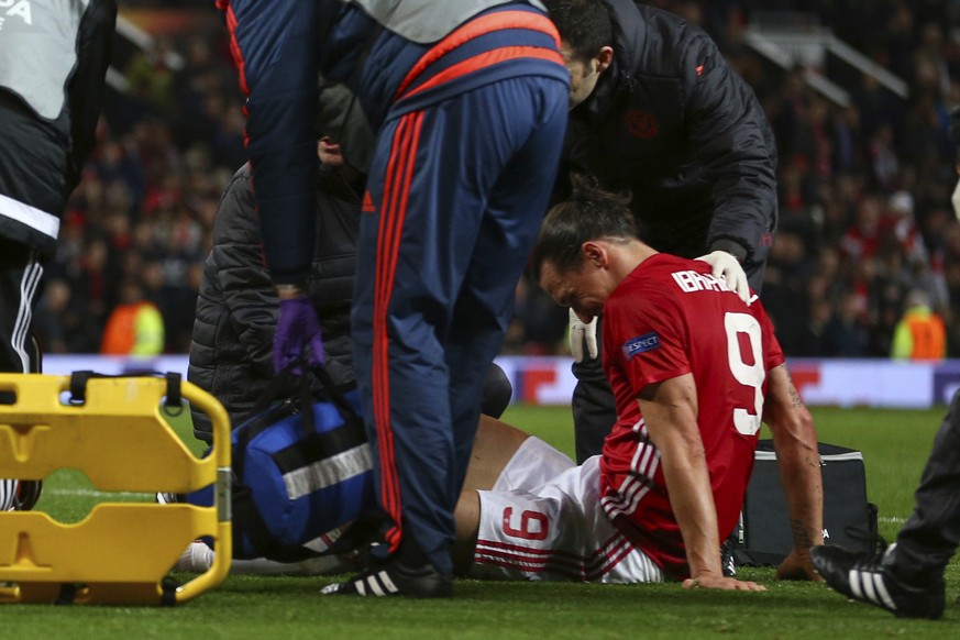 Manchester United&#039;s Zlatan Ibrahimovic sits on the pitch before being taken off with an injury during the Europa League quarterfinal second leg soccer match between Manchester United and Anderlec ...