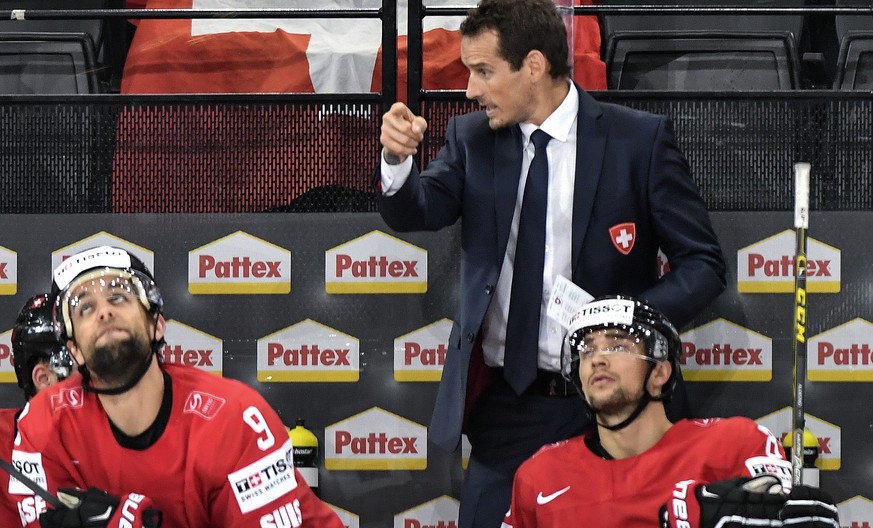 Patrick Fischer, head coach of Switzerland national ice hockey team, right, reacts during their Ice Hockey World Championship group B preliminary round match between Switzerland and Slovenia in Paris, ...