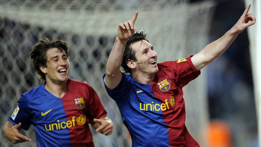 FC Barcelona&#039;s Lionel Messi, from Argentina, right, reacts after scoring with his teammate Bojan Krkic against Espanyol during a Spanish league soccer match at Lluis Companys Stadium in Barcelona ...