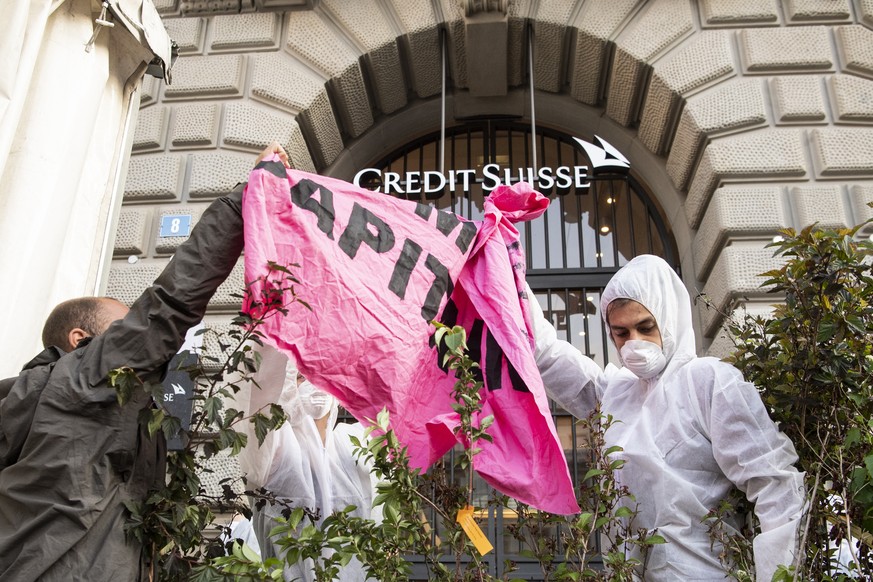 A group of climate activists from the Collective Climate Justice organization is blocking the entrance to the Swiss bank Credit Suisse on Paradeplatz in Zurich, Switzerland, Monday, July 8, 2019. The  ...