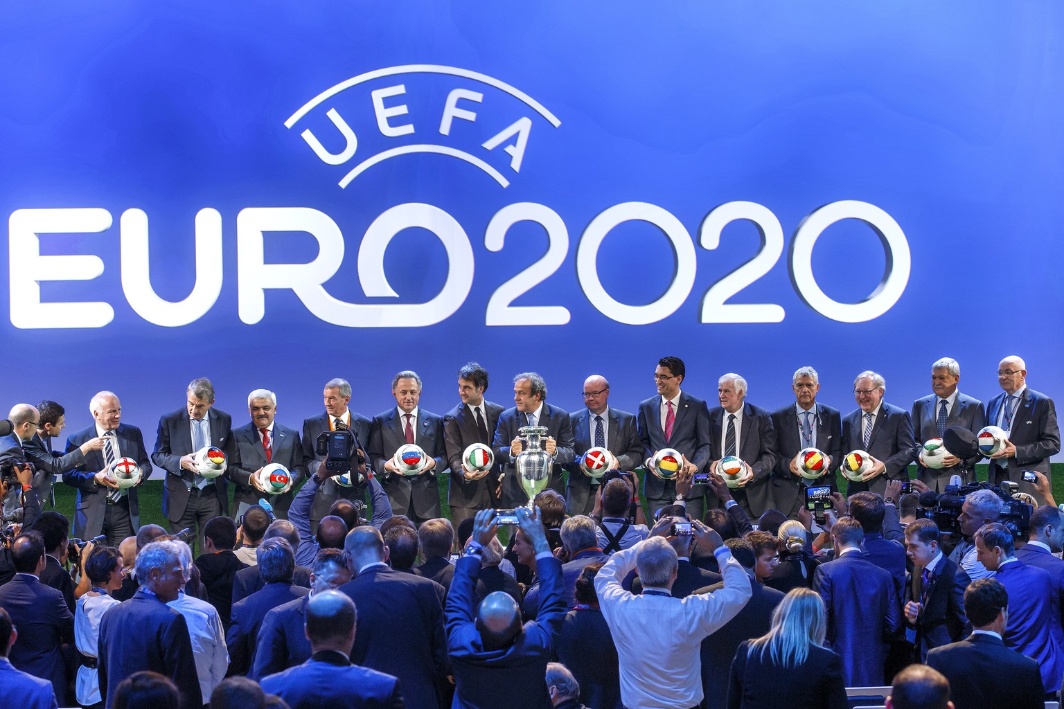 epa08300495 (FILE) - Representatives of the 13 hosts cities of the UEFA EURO 2020 pose with UEFA president Michel Platini (C) for the photographers after the UEFA EURO 2020 hosts announcement ceremony ...