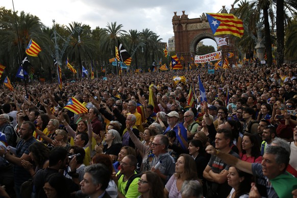 Pro-independence supporters take part in a rally in Barcelona, Spain, Tuesday, Oct. 10, 2017. Catalan President Carles Puigdemont said during his speech in the parliament that the region remained comm ...