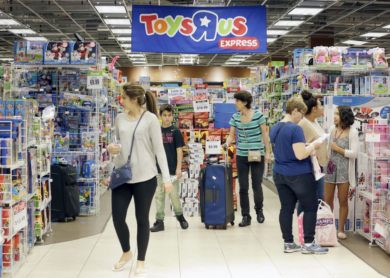Shoppers shop in a Toys R Us store on Black Friday, Nov. 25, 2016, in Miami. Stores open their doors Friday for what is still one of the busiest days of the year, even as the start of the holiday seas ...
